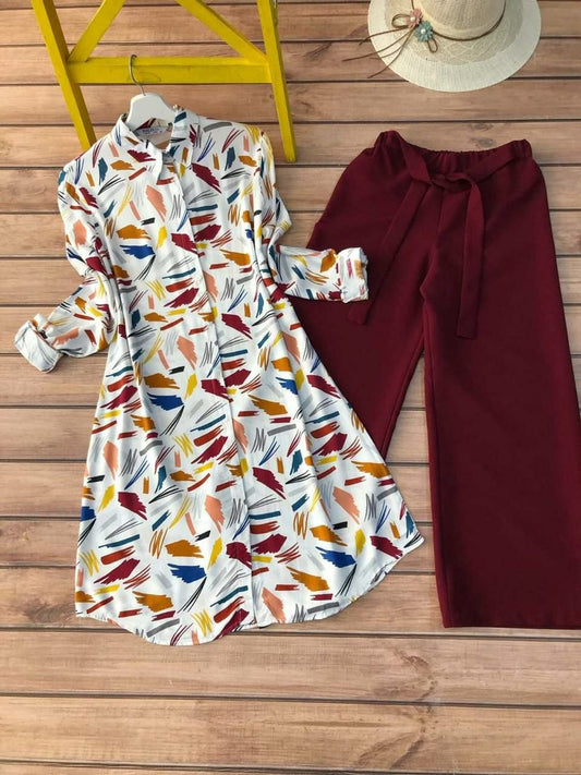 Women's ivory printed long shirt with multi-color brushstroke design paired with wine red tie-waist pants – Co-ord set flatlay on wooden background